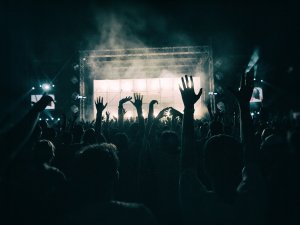 silhouetted hands in the air at concert | Schoolies preparation 2019 | HiRUM