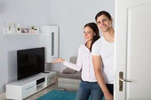 couple welcoming people to the house | peoperty management software for small business | HiRUM