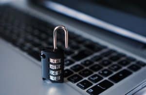 padlock by laptop keyboard | protect your business from internet security scams | HiRUM