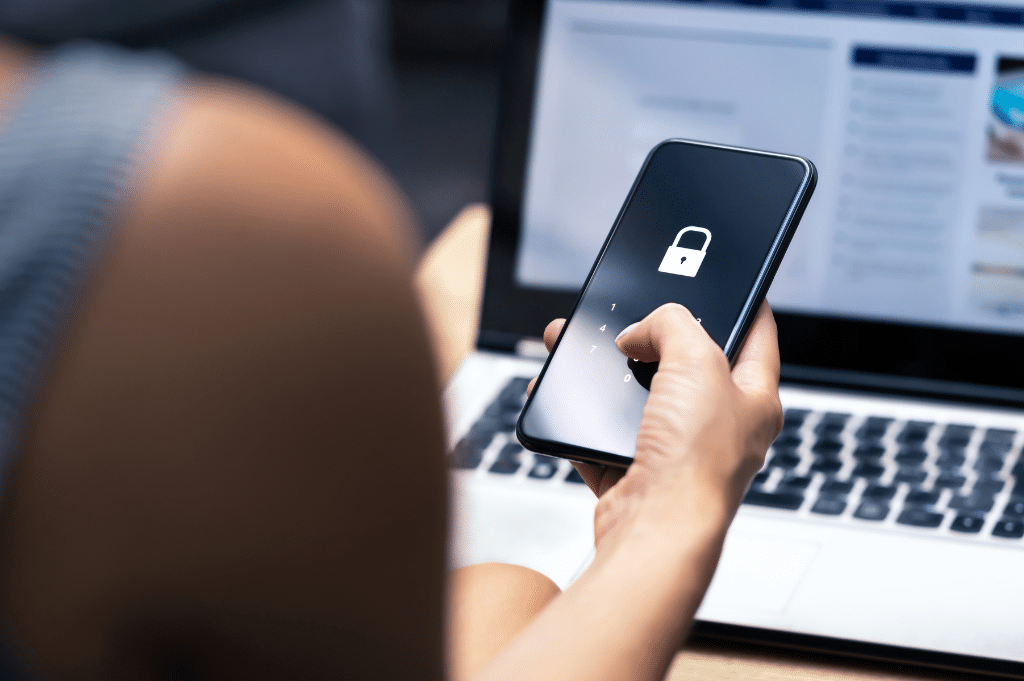 hand holding mobile device with a padlock on screen highlighting a data security risk | HiRUM