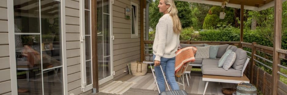 woman with a suitcase arriving at a vacation rental property